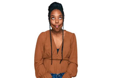 Genç Afro-Amerikalı kadın günlük kıyafetler giyip dudaklarıyla balık suratı yapıyor. Çılgınca ve komik bir jest. Komik ifade. 