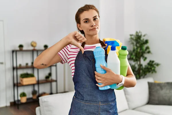 Ung Brunett Kvinna Bär Förkläde Innehav Rengöringsmedel Med Argt Ansikte — Stockfoto