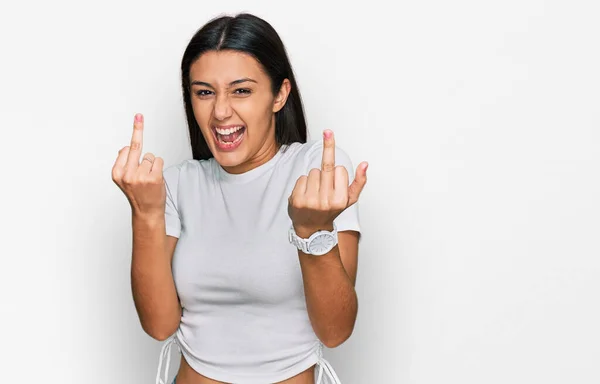 Young Hispanic Girl Wearing Casual White Shirt Showing Middle Finger — Zdjęcie stockowe
