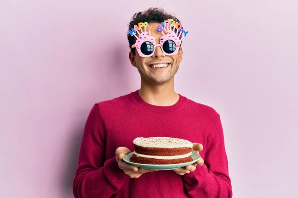 Handsome Hispanic Man Wearing Funny Happy Birthday Glasses Holding Cake — Stock Photo, Image