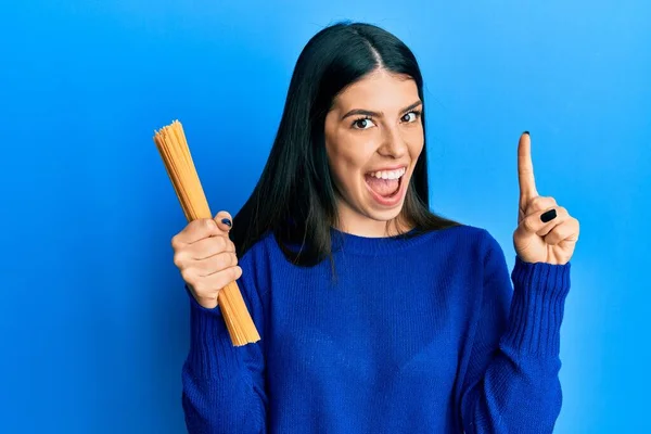 Young Hispanic Woman Holding Uncooked Spaghetti Smiling Idea Question Pointing — Stock Photo, Image