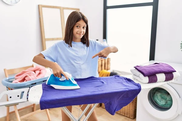 Young Hispanic Girl Ironing Clothes Laundry Room Smiling Happy Pointing — Stock Photo, Image