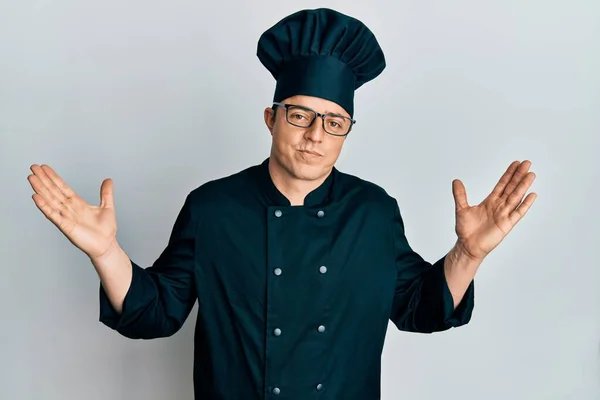 Handsome Young Man Wearing Professional Cook Uniform Hat Clueless Confused — Stock Photo, Image
