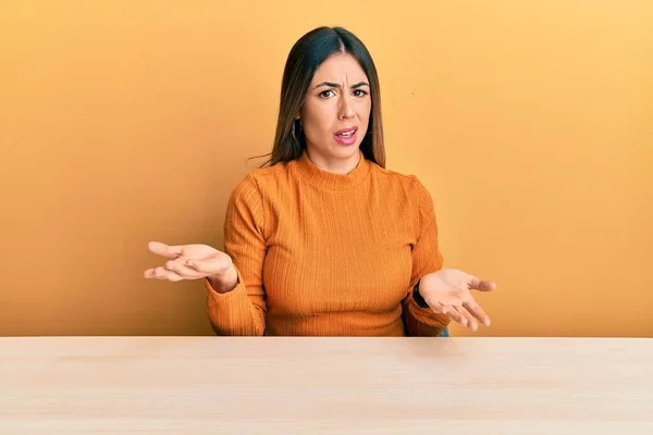 Young Hispanic Woman Wearing Casual Clothes Sitting Table Clueless Confused — Stock Photo, Image