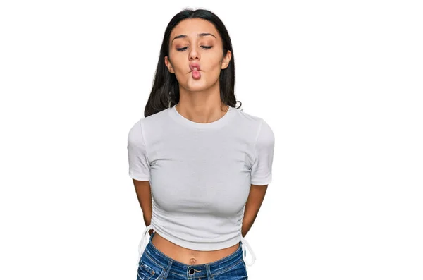 唇で魚の顔を作るカジュアルな白いTシャツを着て若いヒスパニック系の女の子 狂気とコミカルなジェスチャー 面白い表現 — ストック写真