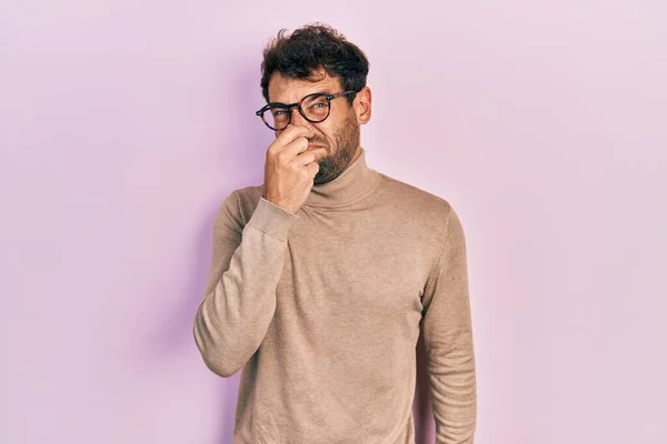 Handsome Man Beard Wearing Turtleneck Sweater Glasses Smelling Something Stinky — Stock Photo, Image