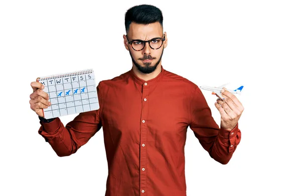Young Hispanic Man Beard Holding Plane Toy Travel Calendar Skeptic — Stock Photo, Image