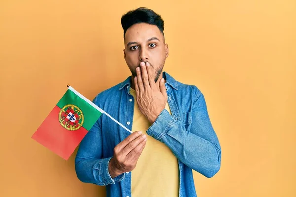 Молодий Арабський Чоловік Тримає Португальський Прапор Покриваючи Рот Рукою Шокований — стокове фото