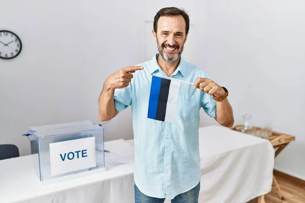 中世の男とともに髭で政治運動選挙保持Estoniaフラグ笑顔幸せなポインティングとともに手と指 — ストック写真