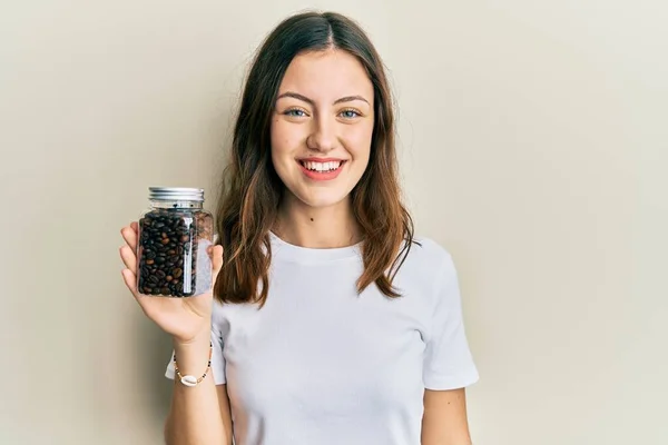 Elinde Kahve Çekirdeği Şişesi Olan Genç Esmer Kadın Pozitif Mutlu — Stok fotoğraf