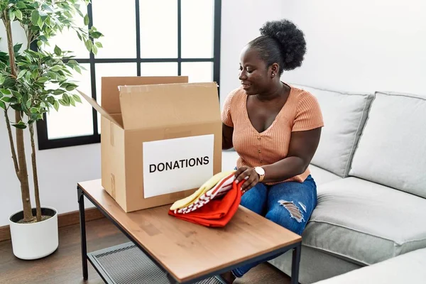 Young African American Woman Folding Clothes Donate Home — Stock Photo, Image