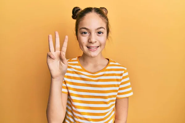 Beautiful Brunette Little Girl Wearing Casual Striped Shirt Showing Pointing — Stock Photo, Image