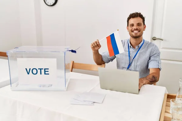 Young Hispanic Man Smiling Confident Holding Russia Flag Working Electoral — Stock Photo, Image