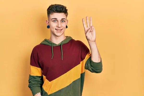 Young Caucasian Boy Ears Dilation Wearing Casual Sweatshirt Showing Pointing — Stock Photo, Image