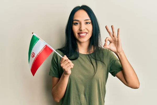 Young Hispanic Girl Holding Iran Flag Doing Sign Fingers Smiling — Stock Photo, Image