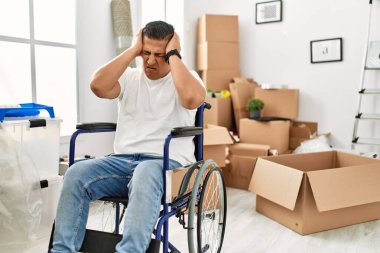 Yeni evimizde tekerlekli sandalyede oturan genç İspanyol adam acı ve migrenden dolayı çaresiz ve stresli bir baş ağrısı çekiyor. Eller başının üstünde.. 