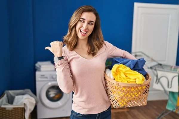 Young Woman Holding Laundry Basket Smiling Happy Face Looking Pointing — ストック写真