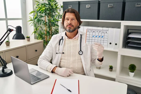 Handsome Middle Age Doctor Man Holding Holidays Calendar Thinking Attitude — Stock Photo, Image