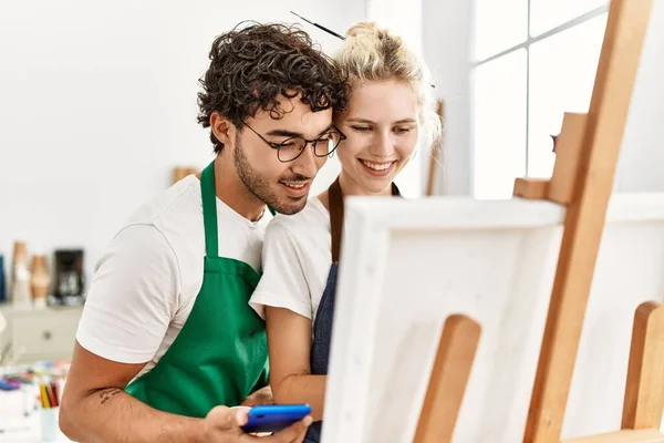 Young Artist Couple Smiling Happy Using Smartphone Painting Art Studio — Stock Photo, Image