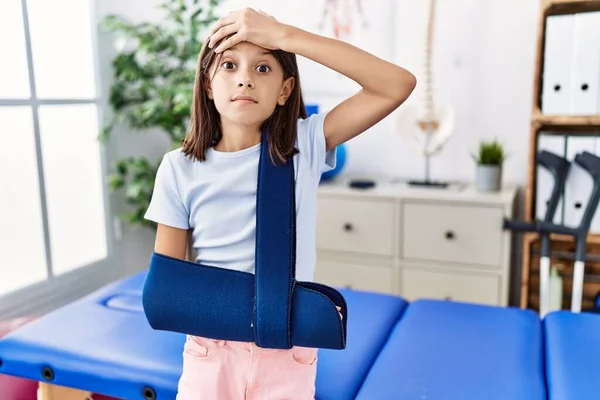 Young Hispanic Girl Wearing Arm Sling Rehabilitation Clinic Stressed Frustrated — Stock Photo, Image