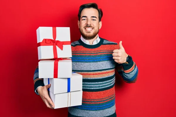 Handsome Caucasian Man Beard Holding Gifts Smiling Happy Positive Thumb — Fotografia de Stock