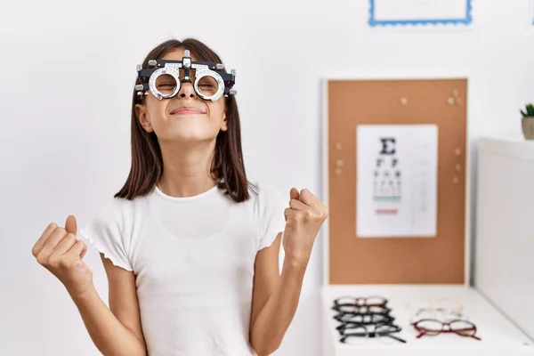 Young Hispanic Girl Wearing Optometry Glasses Screaming Proud Celebrating Victory — Stock Photo, Image