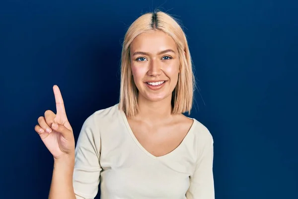 Beautiful Blonde Woman Wearing Casual Sweater Showing Pointing Finger Number — Stockfoto