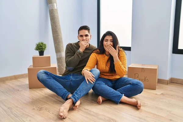 Young Couple Sitting Floor New Home Laughing Embarrassed Giggle Covering — Stok fotoğraf