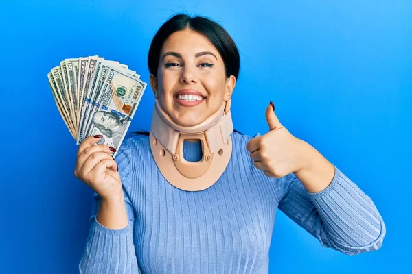 Beautiful Brunette Woman Wearing Cervical Collar Holding Insurance Money Smiling — Stock Photo, Image