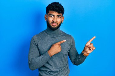 Balıkçı yaka kazak giyen sakallı Arap bir yana endişeli ve gergin, endişeli ve şaşırmış bir ifade takınıyor. 