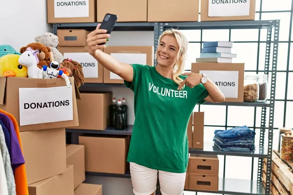 Young Blonde Volunteer Girl Smiling Happy Making Selfie Smartphone Charity — Stock Photo, Image