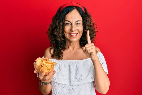 Middle Age Hispanic Woman Holding Potato Chip Smiling Idea Question — Stock Photo, Image