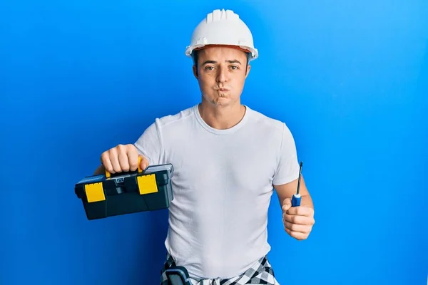 Handsome Young Man Holding Toolbox Screwdriver Puffing Cheeks Funny Face — Stock Photo, Image