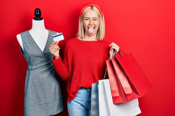 Beautiful Blonde Woman Holding Shopping Bags Credit Card Sticking Tongue — 图库照片