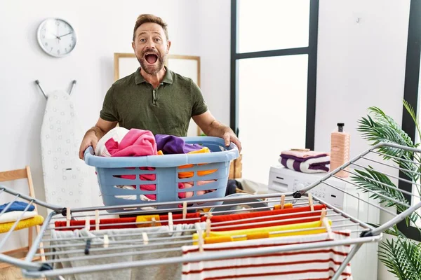 Middle Age Man Doing Laundry Holding Basket Celebrating Crazy Amazed — Stock Photo, Image