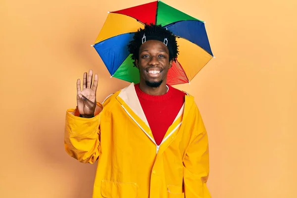 Young African American Man Wearing Yellow Raincoat Showing Pointing Fingers — Fotografia de Stock