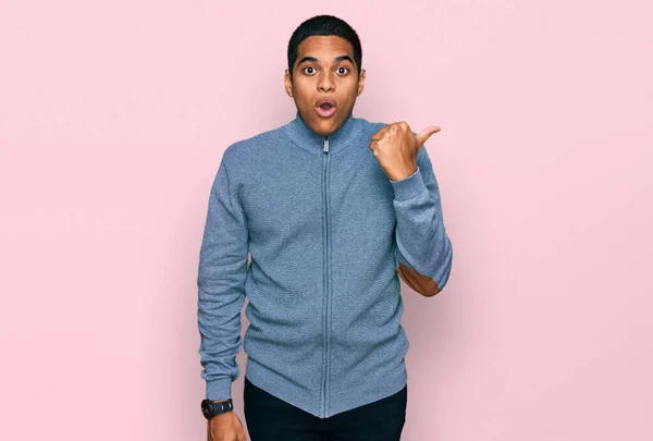 Young Handsome Hispanic Man Wearing Casual Sweatshirt Surprised Pointing Hand — Stock Photo, Image