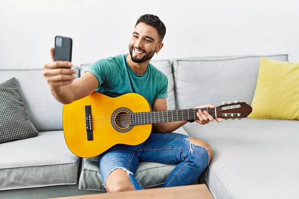 Young Arab Man Make Selfie Smartphone Playing Classical Guitar Home — Φωτογραφία Αρχείου