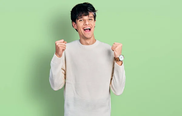 Handsome Hipster Young Man Wearing Casual Winter Sweater Celebrating Surprised — Stock Photo, Image