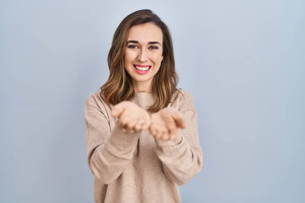 Young Woman Standing Isolated Background Smiling Hands Palms Together Receiving — Stockfoto
