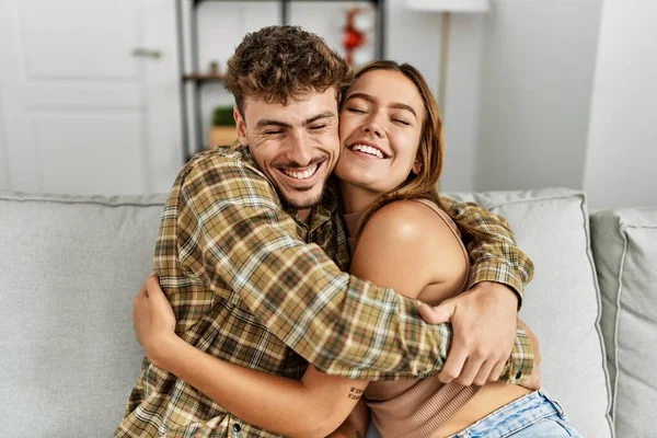 Young Hispanic Couple Smiling Happy Hugging Sitting Sofa Home — Stock Photo, Image