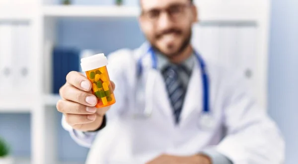 Jonge Spaanse Man Doktersuniform Die Pillen Vasthoudt Kliniek — Stockfoto