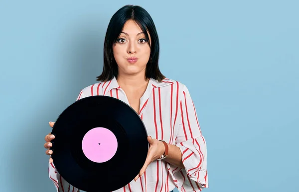 Young Hispanic Girl Holding Vinyl Disc Puffing Cheeks Funny Face — Stock Photo, Image