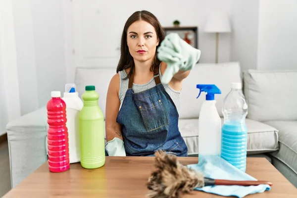 Młoda Brunetka Ubrana Czystszy Fartuch Rękawiczki Sprzątanie Domu Wygląda Nieszczęśliwie — Zdjęcie stockowe