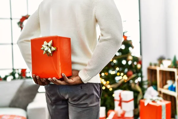 African American Man Holding Gift His Back Standing Christmas Tree — Stock Photo, Image