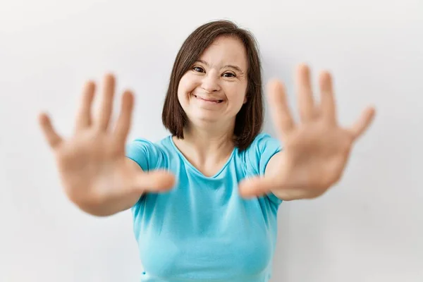 Молодая Женщина Синдромом Дауна Стоит Изолированном Фоне Показывая Указывая Пальцами — стоковое фото