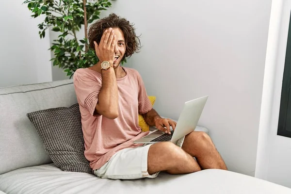 Young Hispanic Man Sitting Sofa Home Using Laptop Covering One — Stock Photo, Image