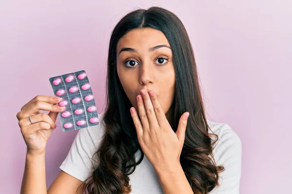 Young Hispanic Woman Holding Pills Covering Mouth Hand Shocked Afraid — Stock Photo, Image