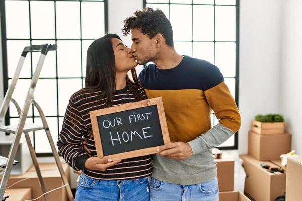 Young Latin Couple Kissing Holding Our First Home Blackboard New — Stock fotografie
