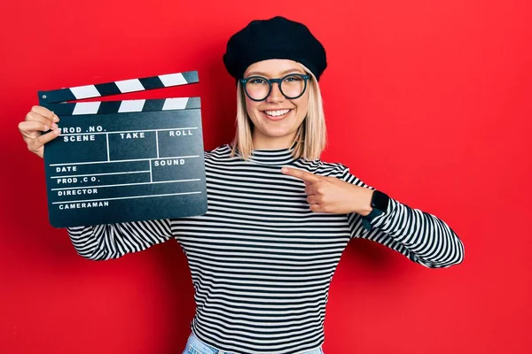 Beautiful Blonde Woman Holding Video Film Clapboard Smiling Happy Pointing — Photo